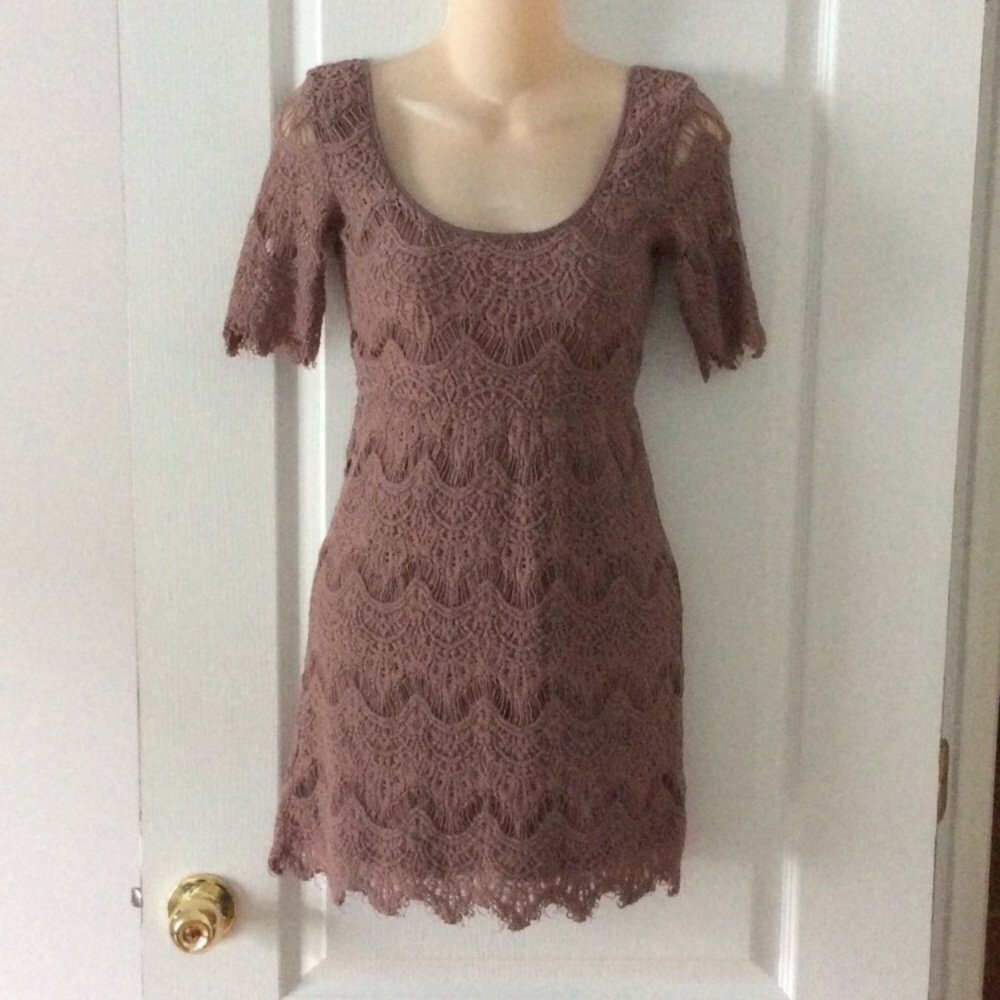 Taupe colored intricate dress.